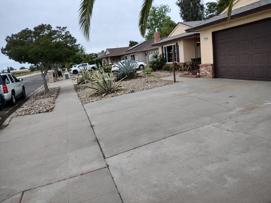 Customer front yard landscaped with water-wise plants and stone